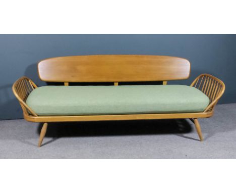 A modern Ercol elm and beech studio settee designed by Lucian Ercolani (1888-1976), with propeller back, on four splayed legs