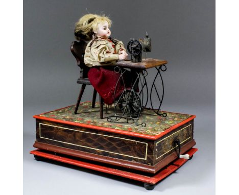A late 19th/early 20th Century German automaton of a seated girl at a treadle sewing machine, the bisque headed doll with art