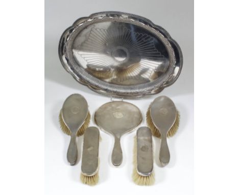 A French silvery metal oval dressing table tray with leaf cast rim and part reeded rim, 14ins x 10.25ins, with guarantee mark