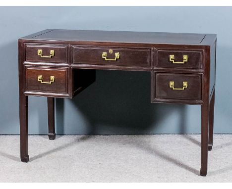 A Chinese hardwood rectangular desk with flush panelled top, fitted five drawers, brass angled handles, on square moulded leg