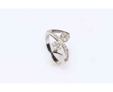 14K white gold and diamond set crossover ring, size N.