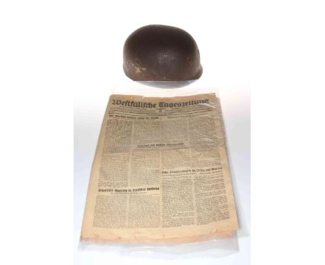 WWII German Paratroopers helmet, together with late war newspaper.