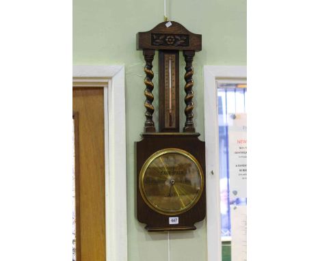 Oak twist column barometer with brass dial.
