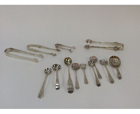 Three pairs of Georgian sugar tongs; a pair of later silver sugar nips; a Georgian silver shell pattern caddy spoon; various 