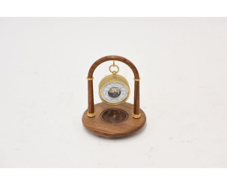 A Universal pocket barometer, hung on a turned wooden stand 