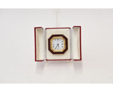 A Cartier Strutt clock, with red enamel decoration, in fitted leather case, 7.5cm