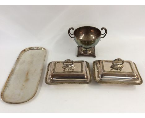 A pair of plated entree dishes, with gadroon border decoration; a plated two handled trophy cup with coin inset to the base; 