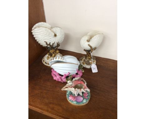 A Royal Worcester blanc de chine and gilt nautilus shell posy vase, supported on a leaf and rockwork base, 21.5cm high; a sma