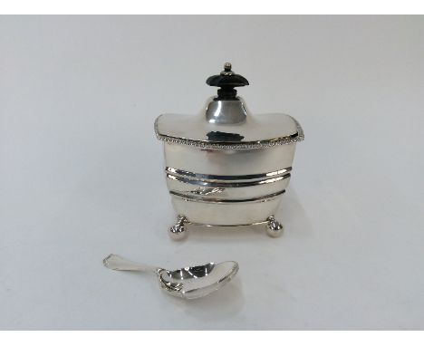 An Edwardian silver tea caddy, the hinged lid surmounted by a black wood lift raised on ball feet, Sheffield 1904, 9cm long; 