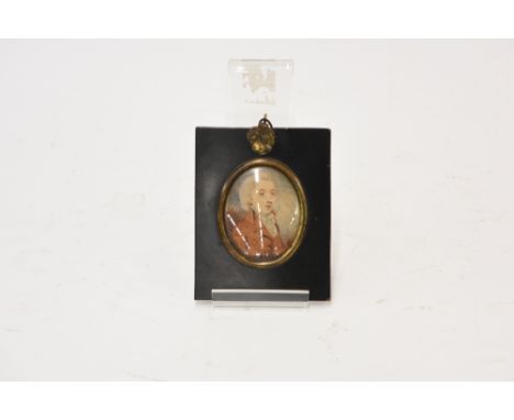 An early 19th Century portrait miniature, depicting a gentleman wearing brown coat and stock, in ebonised and brass mounted f