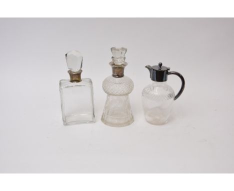A cut glass whisky decanter, of thistle shape with etched foliate decoration and silver collar; another of octagonal shape wi