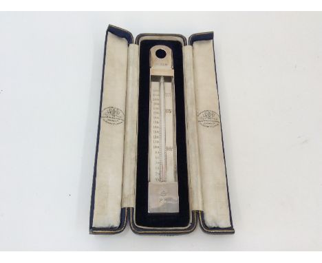 A silver thermometer, by the Goldsmiths & Silversmiths Co. having engraved decoration of a coronet, and stamped R.H., London 