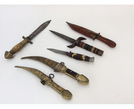 A horn and brass handled hunting knife; a horn handled sheath knife; a dagger with horn and metal bound handle; two Eastern b