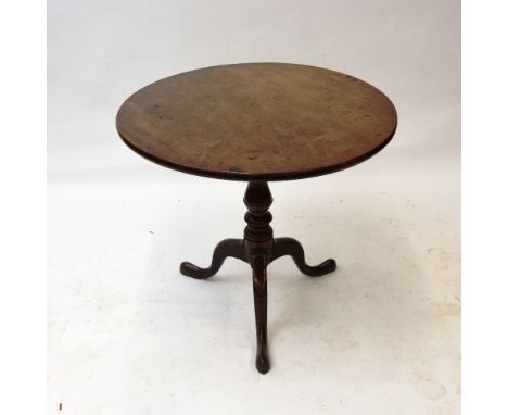An Antique oak tripod table, circular snap top raised on turned  baluster column, 83cm dia.