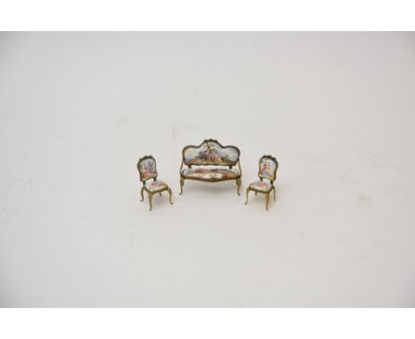 A miniature suite of 19th Century Continental gilt brass and enamel furniture, in the form of an elegant two seater settee an