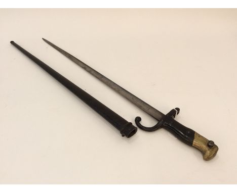 A French bayonet dated 1876, in metal scabbard, leather and brass mounted grip, 52cm long