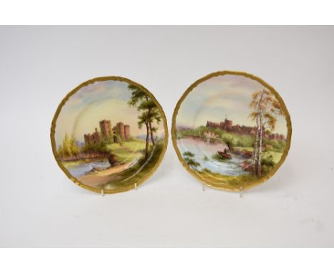 A pair of Royal Worcester cabinet plates, depicting Windsor Castle and Raglan Castle, decorated by G.H. Evans, 27.5cm dia., (