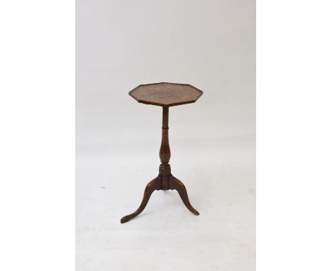A 19th Century elm tripod table, having octagonal top, raised on turned baluster column, 34cm dia. overall
