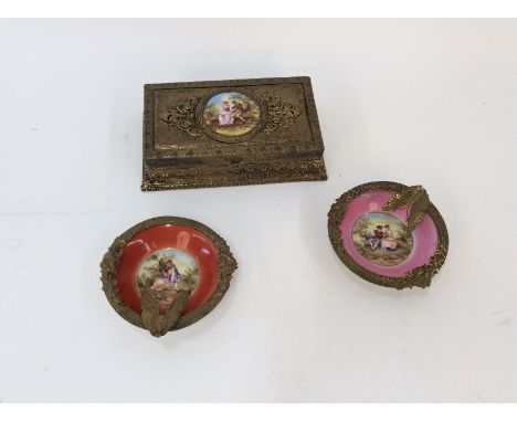 A Continental gilt metal trinket box, the hinged lid with central porcelain panel depicting a romantic scene; and a pair of s