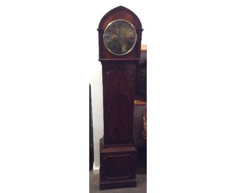 A mahogany long case clock, the lancet shaped hood enclosing a circular brass dial and 8 day movement striking on a gong, tru