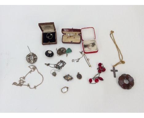 A marcasite set pendant, hung to a fine link chain; a decorative oval paste brooch, having panel with romantic couple; enamel