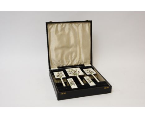 A silver and floral enamel decorated cased five piece dressing set