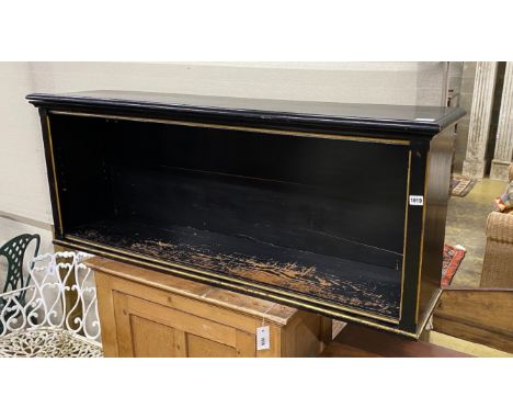 A Victorian ebonized parcel gilt open book shelf, width 142cm, depth 33cm, height 56cm.