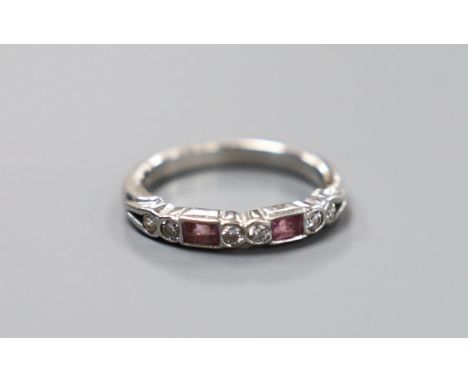 A modern platinum, two stone pink sapphire and six stone diamond set half hoop ring, size H, gross weight 3.9 grams.