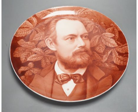 A late 19th century art pottery handpainted portrait dish, 36cm diameter