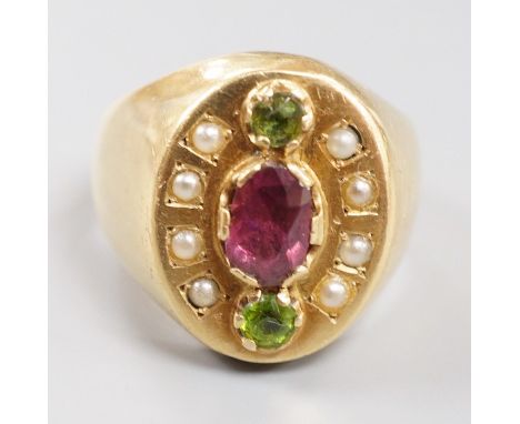 A gold (tests as 18ct), three stone two colour garnet and split pearl cluster set oval dress ring, size V, gross weight 21.7 