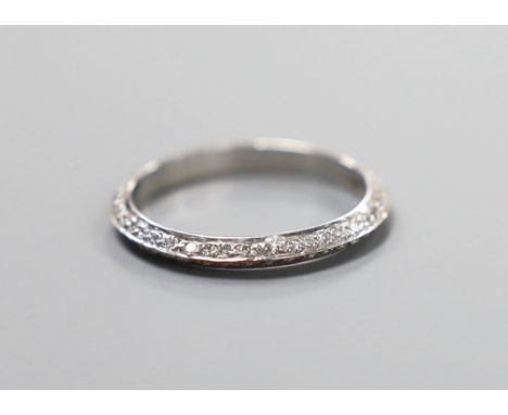 A modern white metal (tests as platinum) and two row diamond chip set full eternity ring, size L, gross weight 1.9 grams.