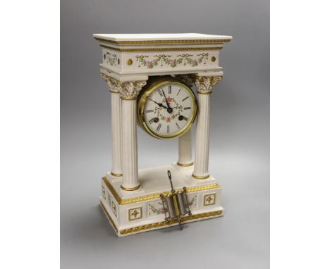 A modern ceramic portico column clock with floral and gilt decoration, with key and pendulum, 37cm tall