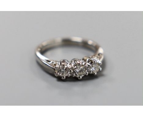 A modern platinum and three stone diamond ring, size H, gross weight 4.8 grams.