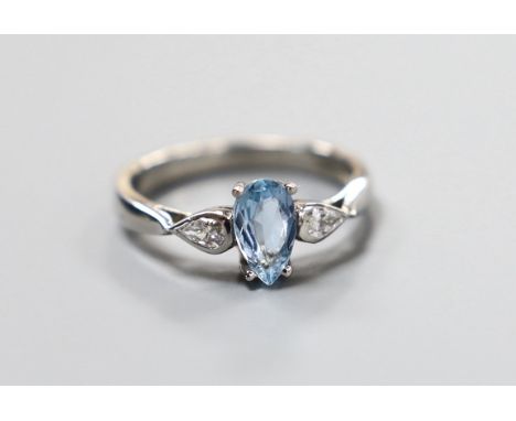 A modern platinum, pear cut aquamarine and two stone pear cut diamond set dress ring, size N, gross weight 5.3 grams, the aqu