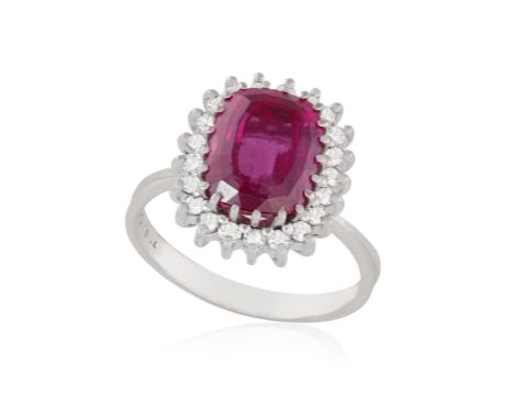 A TOURMALINE AND DIAMOND RINGSet with a cushion-shaped pink tourmaline, within a single-cut diamond surround, mounted in whit