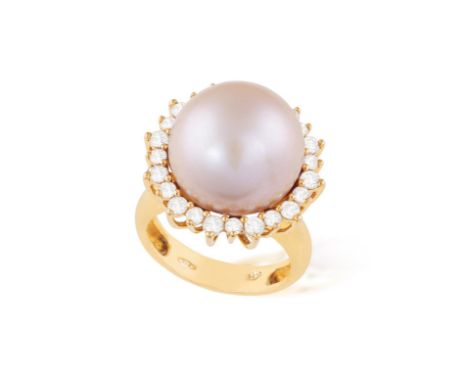 A CULTURED PEARL AND DIAMOND RINGSet with a round cultured pearl of pink tint, within a brilliant-cut diamond surround, to a 