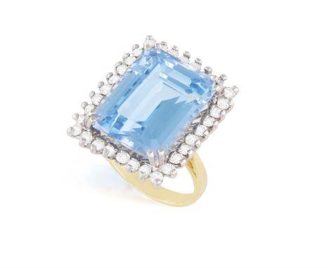 A SPINEL AND DIAMOND RINGOf bi-coloured design, set with a rectangular-shaped (probably synthetic) spinel, within a surround 