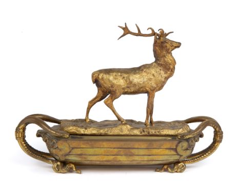 A 19th century gilt metal inkstand with a stag surmount on a boat-shaped base and with serpent handles 30cm wide x 10cm deep 