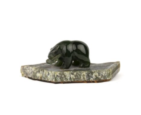 A small Canadian jade carving of a bear and salmon, overall 6cm wide 2.5cm high