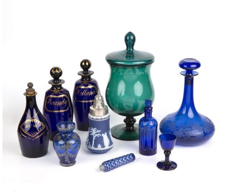 Three Bristol blue glass decanters the largest 22cm high, a blue glass ships decanter, and a silver topped Wedgwood caster