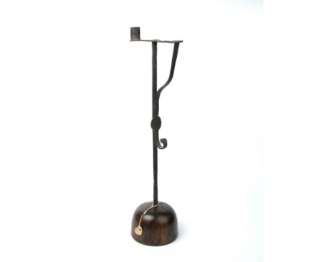 An 18th century wrought iron rush light with a turned oak base 16cm wide 54cm high.