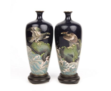 A small pair of early 20th century Japanese cloisonne vases decorated with eagles each 15cm high.  Eagle vase with wings out 