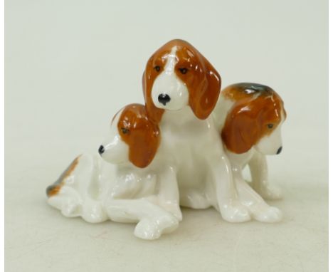 Royal Worcester miniature model of three foxhound puppies: Royal Worcester black mark 3132, length 8.5cm.