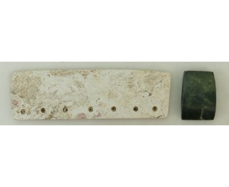 Two Neolithic style Jade Axe Heads: A calcified jade axe featuring seven holes on the top side with overall off-white colour 