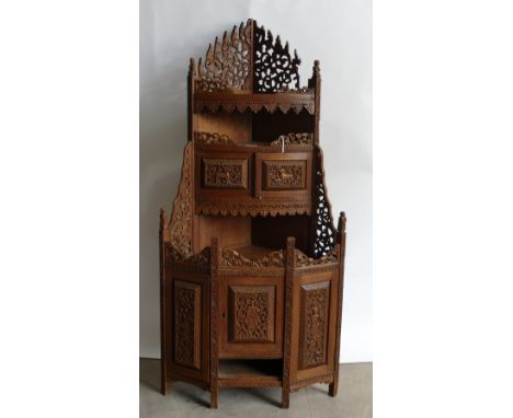 Burmese carved Teak Corner unit: Repaired carving noted to top edging and figures missing to central pillars, 134cm height x 
