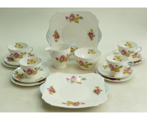 A collection of Shelley Begonia patterned tea ware: To include 10 x saucers, 12 x side Plates, 12 x cups, sandwich plate, cre