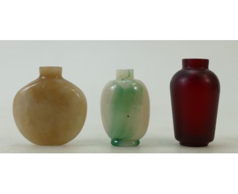 Three Chinese Peking Glass and Jade Snuff Bottles: A round shape beige colour jade bottle, a ruby red Peking glass bottle and