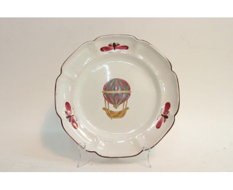 A French Luneville ceramic plate depicting a hand painted hot air balloon, diameter approx 25cm.