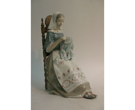 A large boxed Lladro figure of a girl sewing