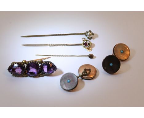 Three stick pins, amethyst brooch and a pair of gilt cufflinks.